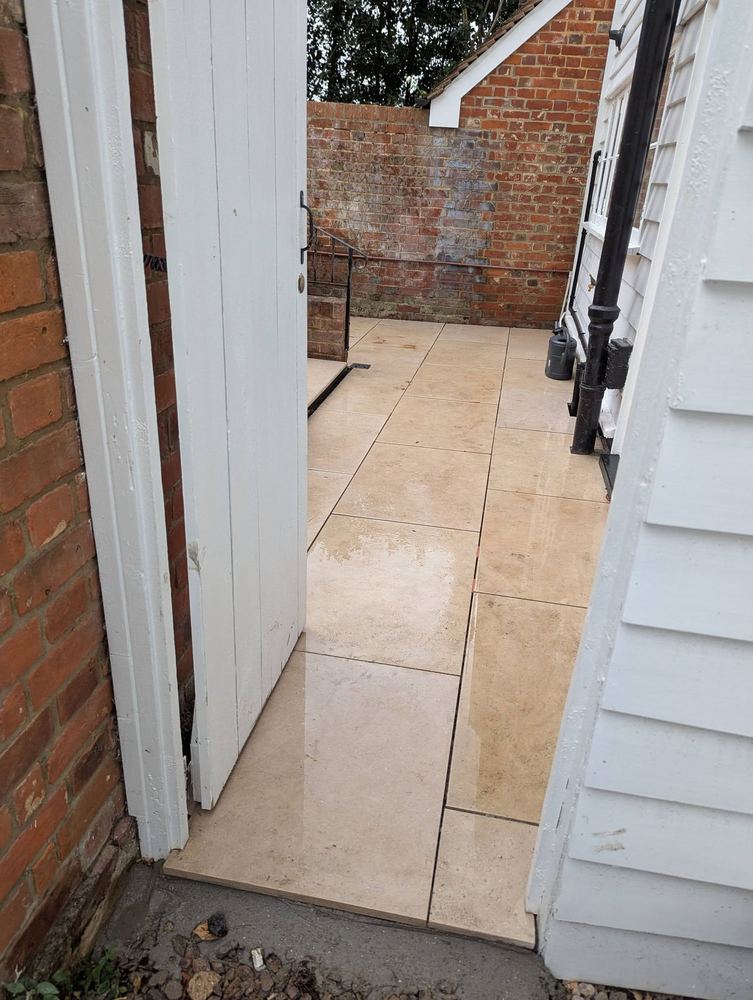 Porcelain paving carried through a white gate into the side passage